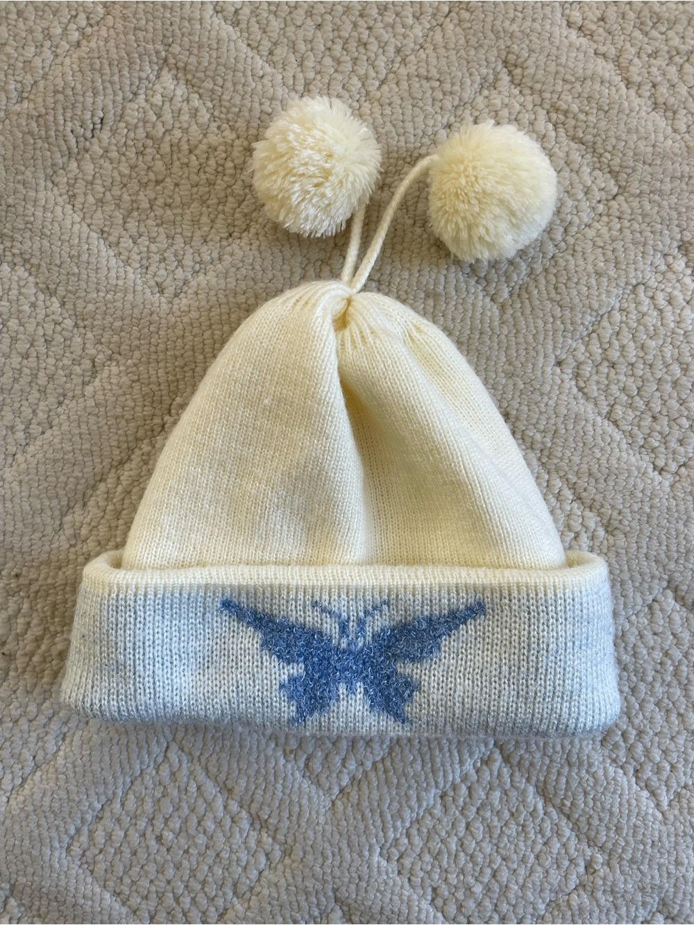 Cream Pom Pom Beanie with Blue Butterfly Detail
